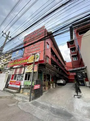 a red building with a sign on the side of it at Ratanawong Place 553 in Bangkok