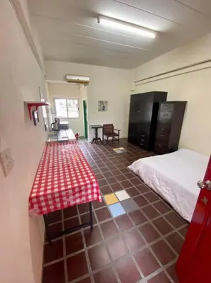 a room with a bed and a table in it at Ratanawong Place 510 in Bangkok