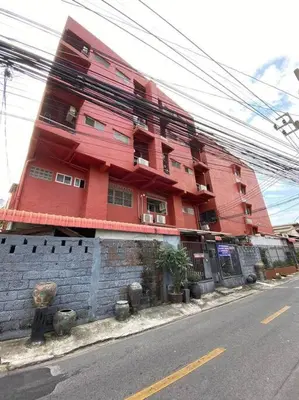 a red building on the side of a street at Ratanawong Place 516 in Bangkok