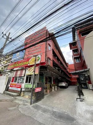a building on a street with power lines above it at Ratanawong Place 401 in Bangkok