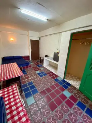 a room with a colorful tile floor in a room at Ratanawong Place 401 in Bangkok