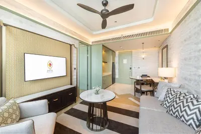 a living room with a couch and a table at Eastin Grand Hotel Phayathai in Bangkok