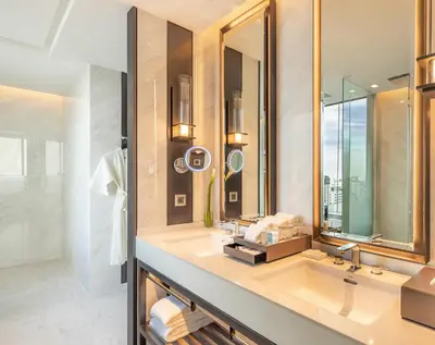 a bathroom with a sink and a mirror at Eastin Grand Hotel Phayathai in Bangkok