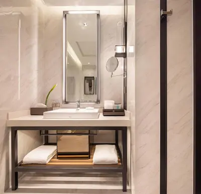 a bathroom with a sink and a mirror at Eastin Grand Hotel Phayathai in Bangkok