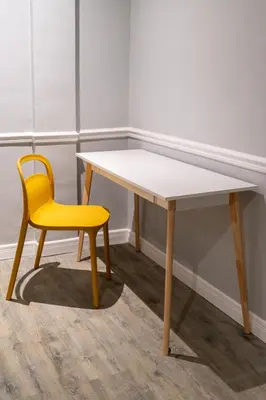 a yellow chair sitting next to a white table and a yellow desk at Baansuansao in Bang Rak