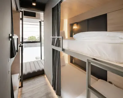 a bedroom with a bunk bed and a staircase at Speck Bangkok in Bangkok