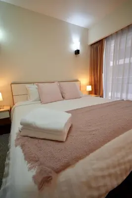 a bedroom with a large white bed with two pillows at Baan Sukhumvit14 in Bangkok