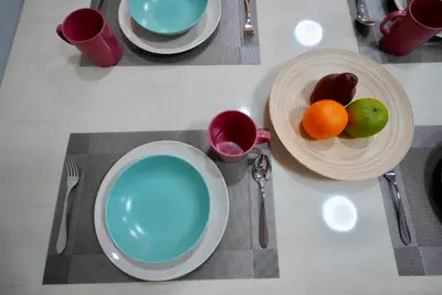 a table with plates and bowls with fruit on it at Baan Sukhumvit14 in Bangkok