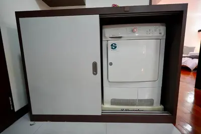 a small appliance in a cabinet in a kitchen at Baan Sukhumvit14 in Bangkok
