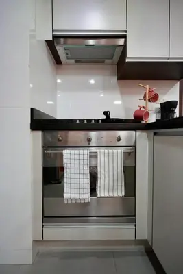 a kitchen with an oven with towels on it at Baan Sukhumvit14 in Bangkok