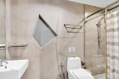 a bathroom with a shower and a toilet and a sink at Chill Inn Bangkok in Bang Kapi