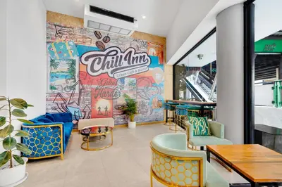 a restaurant with a mural on the wall at Chill Inn Bangkok in Bang Kapi