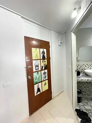 a bathroom with a door with pictures on it at Impact Arena C3 Milo in Nonthaburi
