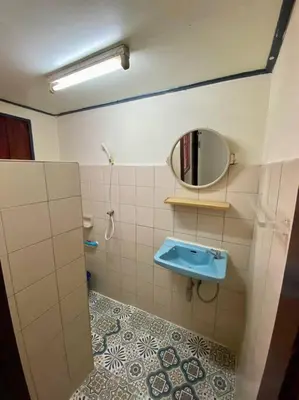 a bathroom with a blue sink and a mirror at Ratanawong Place 552 in Bangkok