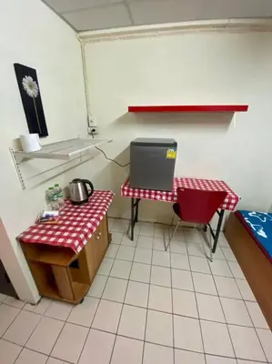 a room with a kitchen with a table and a laptop at Ratanawong Place 559 in Bangkok