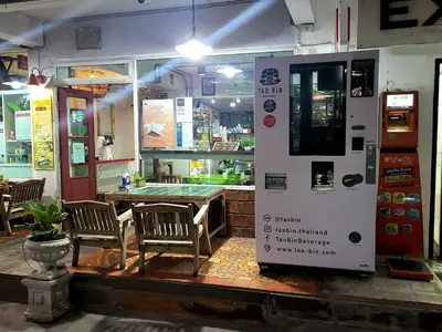 a restaurant with a table and a vending machine at Ratanawong Place 559 in Bangkok