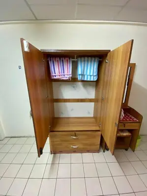 a wooden cabinet sitting on top of a tiled floor at Ratanawong Place 559 in Bangkok