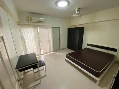 an empty room with a bed and a window at My Space 77 in Ban Khlong Khwang Klang