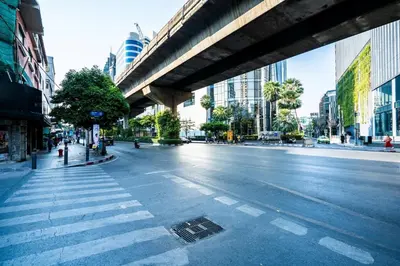 an empty street with an overpass in a city at XX GO INN Sukhumvit 20 Bts Asoke-Phrom Phong in Bangkok