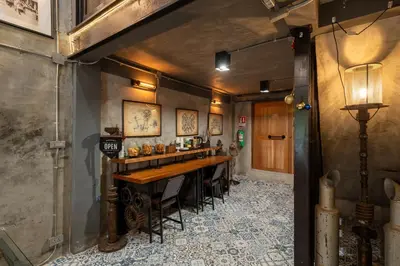 a bar in a room with a table and chairs at House of Machine Boutique Hotel in Bangkok