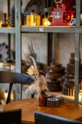 a wooden table with a jar with dried grass on it at House of Machine Boutique Hotel in Bangkok