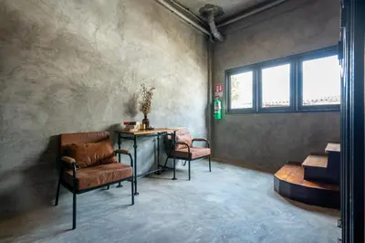 a room with a desk and a chair and a table at House of Machine Boutique Hotel in Bangkok