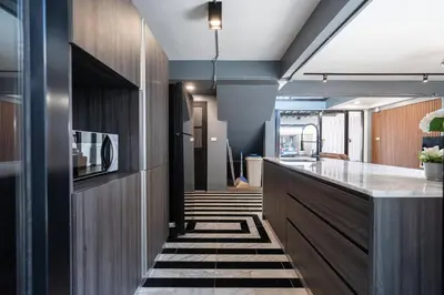 a hallway with a kitchen with a counter and a room at S21 Mellow Phromphong in Bangkok