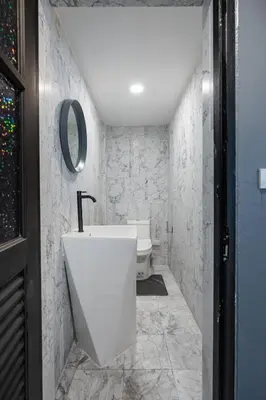 a bathroom with a white tub and a toilet at S21 Mellow Phromphong in Bangkok