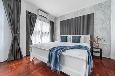 a bedroom with a white bed with a blue blanket on it at S21 Mellow Phromphong in Bangkok