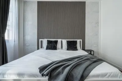 a bedroom with a large bed with white sheets and pillows at S21 Mellow Phromphong in Bangkok