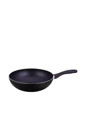 a black cast iron frying pan on a white background at Elio Del Ray in Bangkok