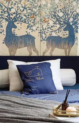 a bed with blue and white pillows and a wall at Elio Del Ray in Bangkok