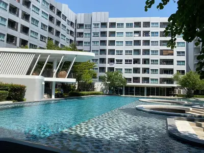 a swimming pool in front of a building at Elio Del Ray in Bangkok
