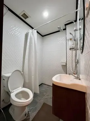 a bathroom with a toilet and a sink at DiscoveryHome at Pratunam market in Bangkok