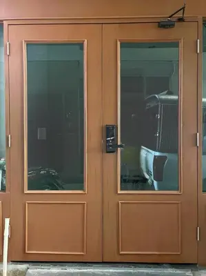 a wooden door with two windows on a building at DiscoveryHome at Pratunam market in Bangkok