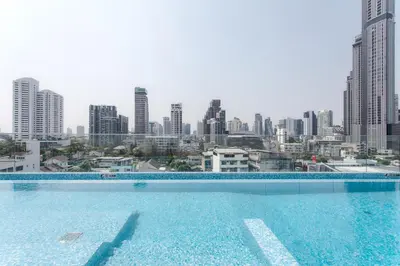 a swimming pool with a view of a city at GM Residence in Bangkok