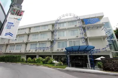 a large white building with blue decorations on it at Beat Hotel Bangkok in Bangkok