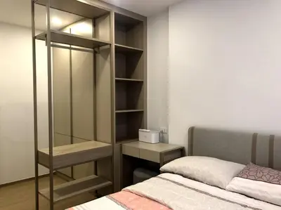 a bedroom with a bed and a glass closet at NEST Sukhumvit71 BTS - Pool, Fitness, Parking, Wifi in Bangkok