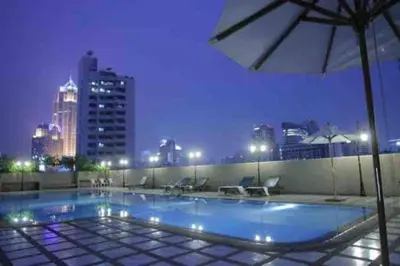 a swimming pool on top of a building at night at SelfCheckIn Omni Tower Sukhumvit4 NaNa Asoke BTS MRT Hispeed WiFi Pool&Gym in Bangkok