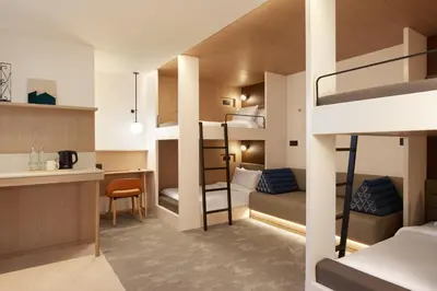 a small room with bunk beds and a kitchen at ASAI Bangkok Sathorn in Bangkok