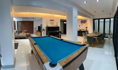 a pool table in the middle of a living room at Joyful Modern Home with Foods and MRT Rama 9 Nearby in Bangkok