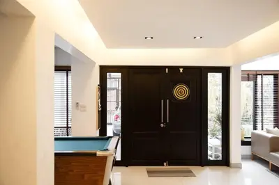 a living room with a pool table in front of a door at Joyful Modern Home with Foods and MRT Rama 9 Nearby in Bangkok