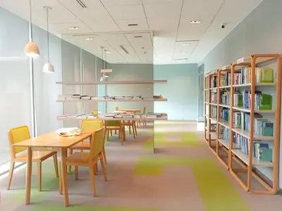 a library with tables and chairs and bookshelves at Rooms bangkok nearby Onnut bts in Amphoe Phra Khanong