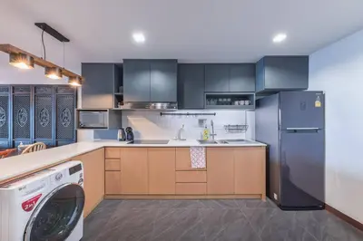 a kitchen with a refrigerator and a washer in it at Central Bangkok, 5 stars river view & characteristic decor in Bangkok