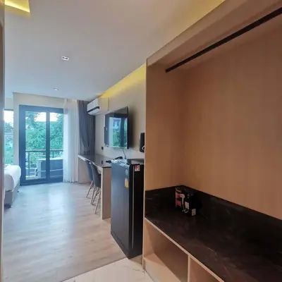 a room with a kitchen and a living room at The 9 Residence Hotel in Bangkok