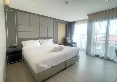 a bedroom with a large bed with two towels on it at The 9 Residence Hotel in Bangkok
