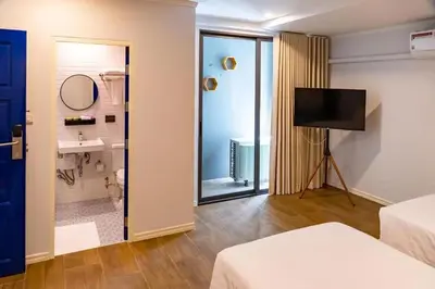 a room with a bathroom with a sink and a mirror at J PLACE HOTEL in Bangkok
