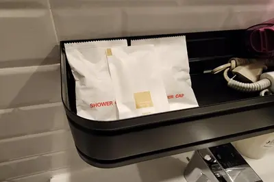 a black briefcase with a phone and a cord at J PLACE HOTEL in Bangkok