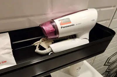 a pink and white hair dryer in a box at J PLACE HOTEL in Bangkok