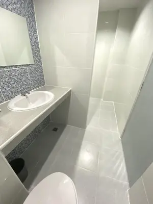 a white bathroom with a sink and a toilet at บ้านสายสิริ in Ban Bang Talat